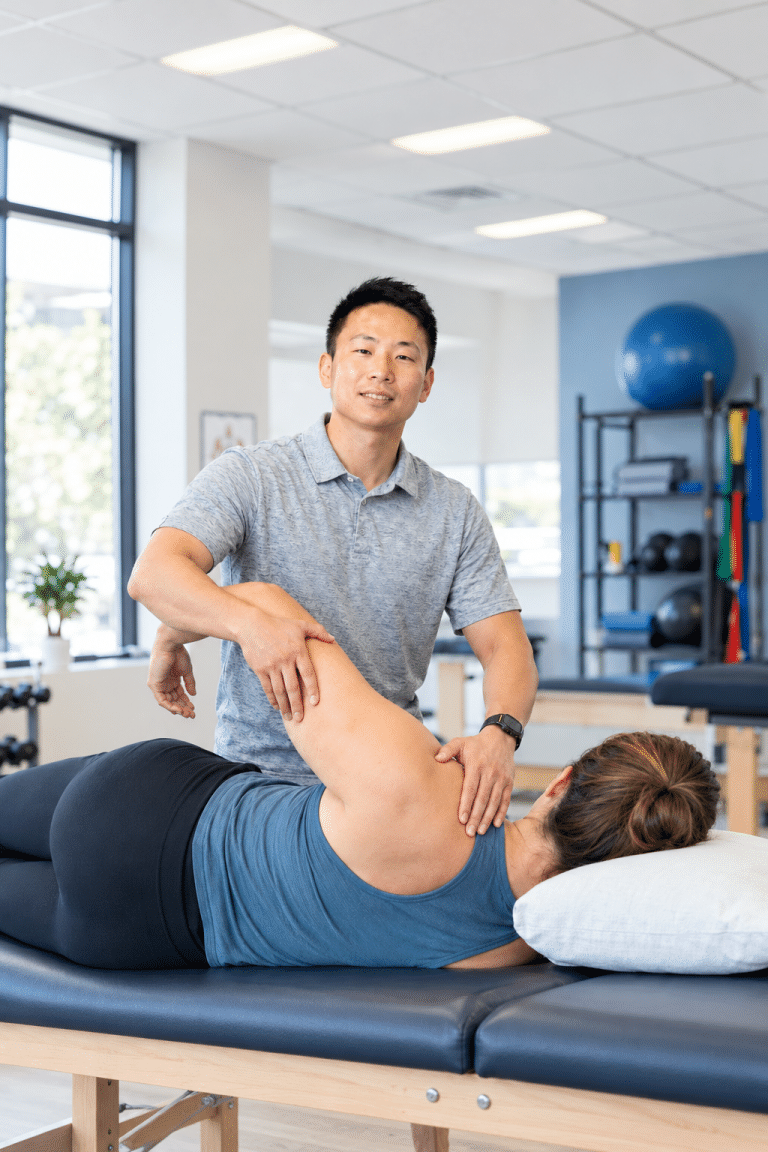Physical therapist checking neck range of motion during a first visit in Sugar Land.